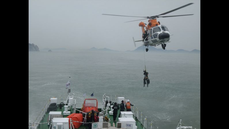 A member of the South Korean Coast Guard is pulled up from a helicopter while working at the site of a capsized ferry Wednesday, April 16, near Jindo, South Korea. The ferry was carrying hundreds of people, many of them high school students on a field trip, when <a href="http://www.cnn.com/2014/04/15/asia/gallery/south-korea-sinking-ship/index.html">it started sinking</a> on Wednesday morning. At least 25 people were confirmed dead as of Thursday, April 17, and while nearly 200 passengers had been rescued, nearly 300 remained unaccounted for.