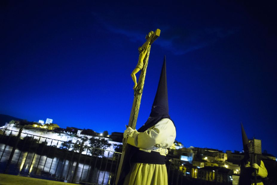 Penitents from Jesus del Via Crucis brotherhood cross a bridge as they take part in a procession in Zamora, Spain, on April 15. 