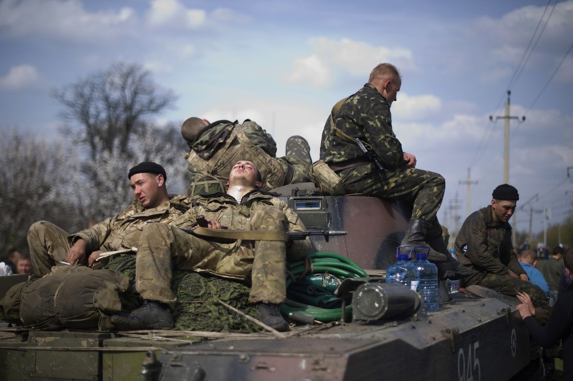 Ukrainian soldiers rest near the eastern Ukrainian town of Kramatorsk on Wednesday, April 16. Ukraine has seen a sharp <a href="http://www.cnn.com/2014/03/26/world/gallery/ukraine-crisis/index.html">rise in tensions</a> since a new pro-European government took charge of the country in February. Moscow branded the new government illegitimate and annexed Ukraine's Crimea region last month, citing threats to Crimea's Russian-speaking majority. And in eastern Ukraine, pro-Russian separatists have seized government and police buildings in as many as 10 towns and cities.