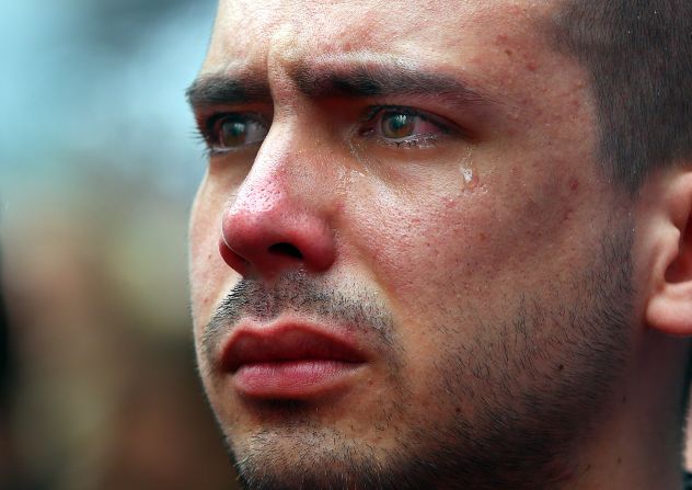 Boston University student Sebastian Filgueira-Gomez has tears in his eyes during a moment of silence held Tuesday, April 15, on the <a href="http://www.cnn.com/2014/04/15/us/gallery/boston-bombing-memorial/index.html">one-year anniversary of the Boston Marathon bombings</a>. Filgueira-Gomez was standing on Boston's Boylston Street, a block from the marathon's finish line.