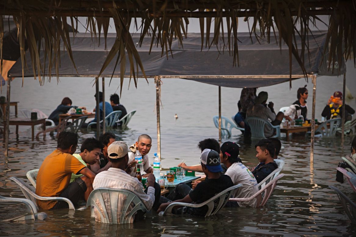 Burmese teenagers sit at a restaurant near Kandawgyi Lake during Thingyan, the Buddhist water festival leading up the Burmese New Year, on Wednesday, April 16. During the festival, staying dry is a rarity. Water symbolizes the washing away of the previous year's bad luck and sins.