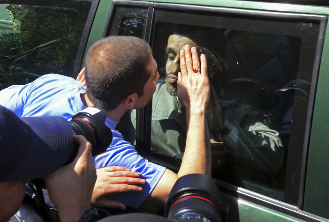 Former Iranian President Mahmoud Ahmadinejad kisses a well-wisher from behind the window of his car as he leaves Friday prayers in Tehran, Iran, on April 11.