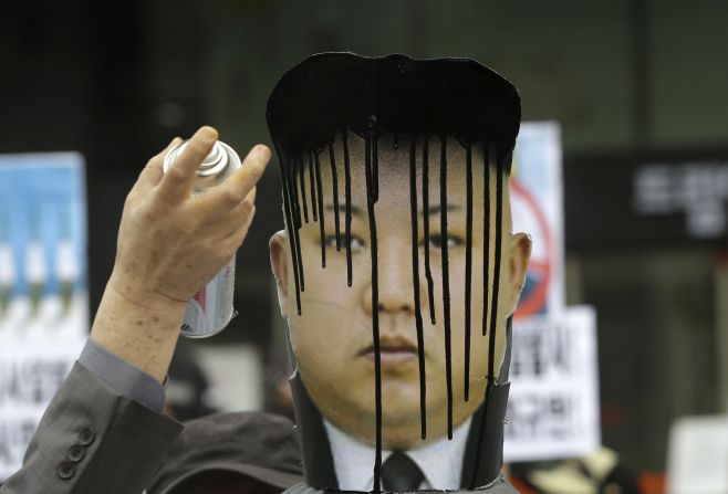 A picture of North Korean leader Kim Jong Un is sprayed by a protester during an anti-North Korea rally Tuesday, April 15, in Seoul, South Korea.