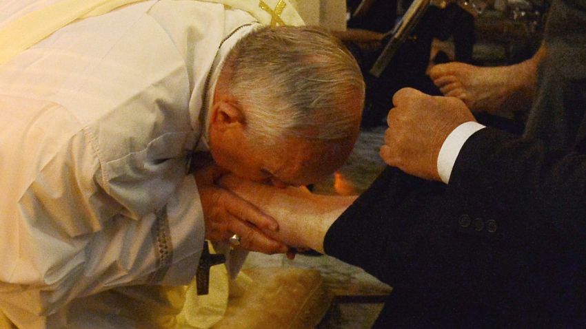 Pope Francis  kisses the foot of a person as he performs the traditional Washing of the feet Thursday.