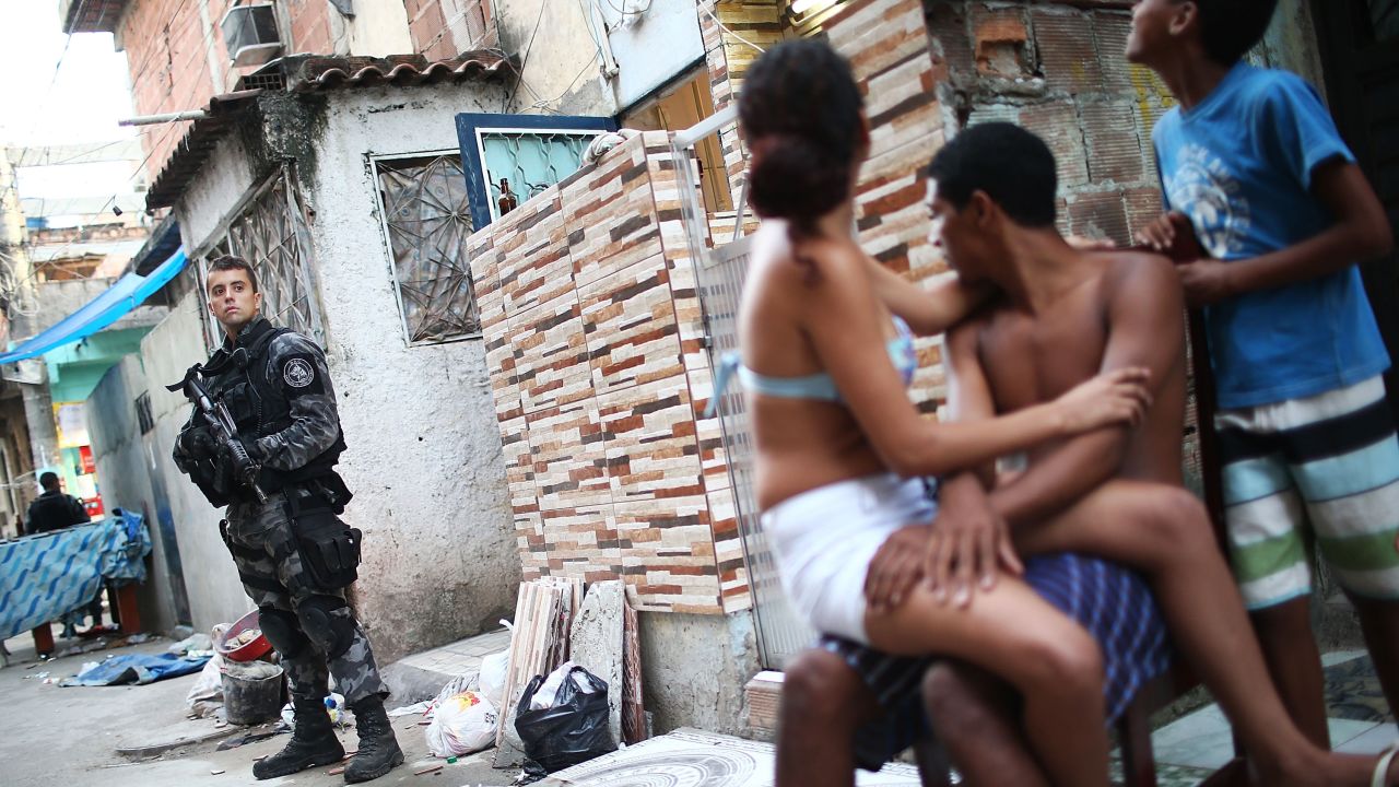 A Brazilian military police officer keeps watch after entering the Complexo da Mare, one of the largest slums, or favelas, in Rio de Janeiro, on March 30.