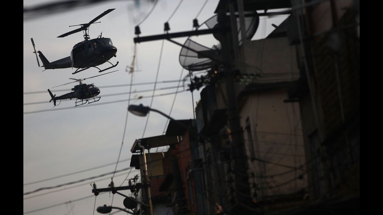 Police helicopters patrol over the favela.