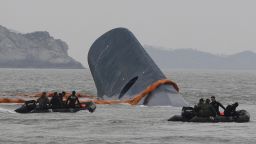 South Korean Coast Guard officers search for missing passengers aboard a sunken ferry in the water off the southern coast near Jindo, South Korea, Thursday, April 17/