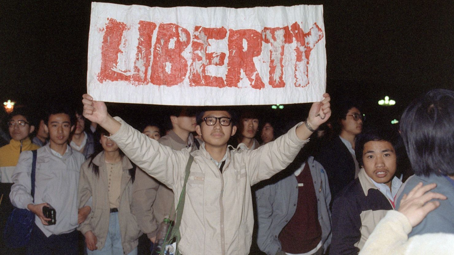 A student displays a banner on the march to Tiananmen Square, Beijing, 25 years ago.