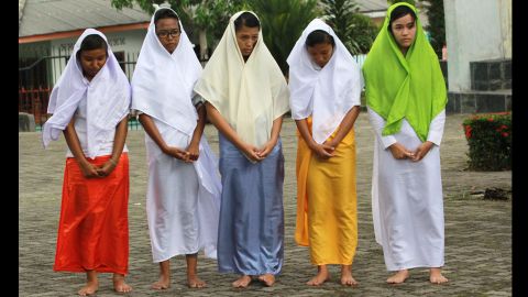 People take part in a Stations of the Cross re-enactment at the Raja Agung church in Bintan Island, Indonesia, on Good Friday.
