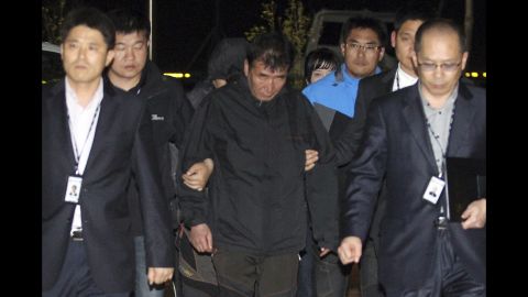 Lee Joon Suk, the captain of the Sewol, is escorted to the court that issued his arrest warrant Friday, April 18, in Mokpo, South Korea.