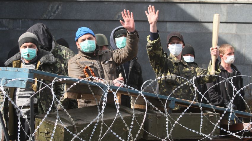 Pro-Russian activists guard a barricade set at the Ukrainian regional Security Service building on the eastern city of Donetsk on April 7, 2014. 