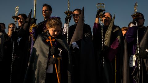 Worshippers of the Santisimo Cristo del Salvador brotherhood pray around the crucifix during a procession April 18 in Valencia, Spain.
