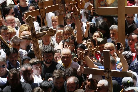 Christian Orthodox pilgrims carry wooden crosses during a Good Friday procession in Jerusalem.