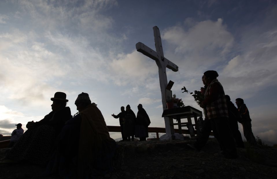 Faithful take part in a pilgrimage to the Cross of Villa Armonia during a possession to mark Good Friday in La Paz, Bolivia.