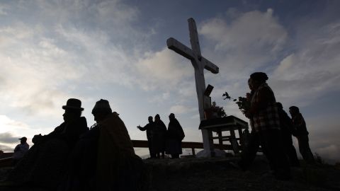 Faithful take part in a pilgrimage to the Cross of Villa Armonia during a possession to mark Good Friday in La Paz, Bolivia.