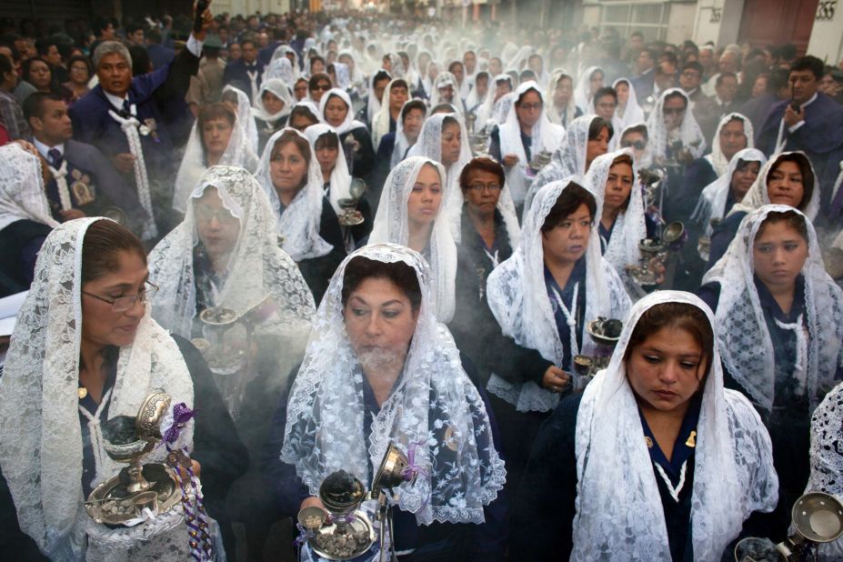 Women burn incense while participating in a Good Friday procession honoring the patron saint of Lima, Peru, on April 18.