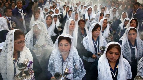 Women burn incense while participating in a Good Friday procession honoring the patron saint of Lima, Peru, on April 18.
