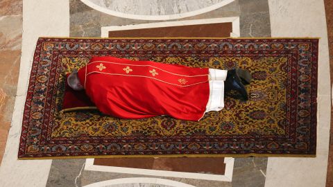 Pope Francis lies on the floor in prayer before presiding over a Good Friday service in St. Peter's Basilica.
