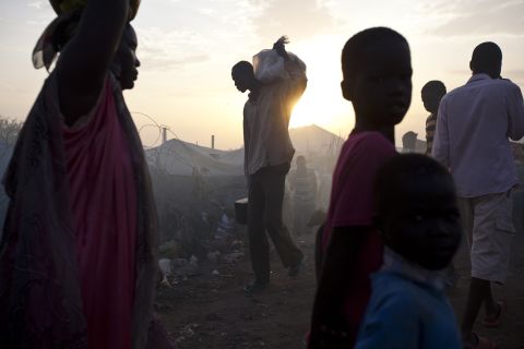 A man carries a bag on his shoulder at a camp in Malakal, South Sudan, on Wednesday, March 19.