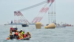 A giant offshore crane is seen near the buoys installed to mark a capsized ferry as rescue members search for missing passengers at sea off Jindo on April 18, 2014. South Korean divers renewed efforts on April 18 to access a capsized ferry in which hundreds of schoolchildren are feared trapped, as the grief and frustration of anguished parents gave way to anger and recrimination.AFP PHOTO / JUNG YEON-JEJUNG YEON-JE/AFP/Getty Images