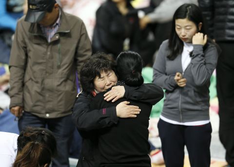 Family members of missing passengers hug as they await news of their missing relatives at Jindo Gymnasium on April 19. 