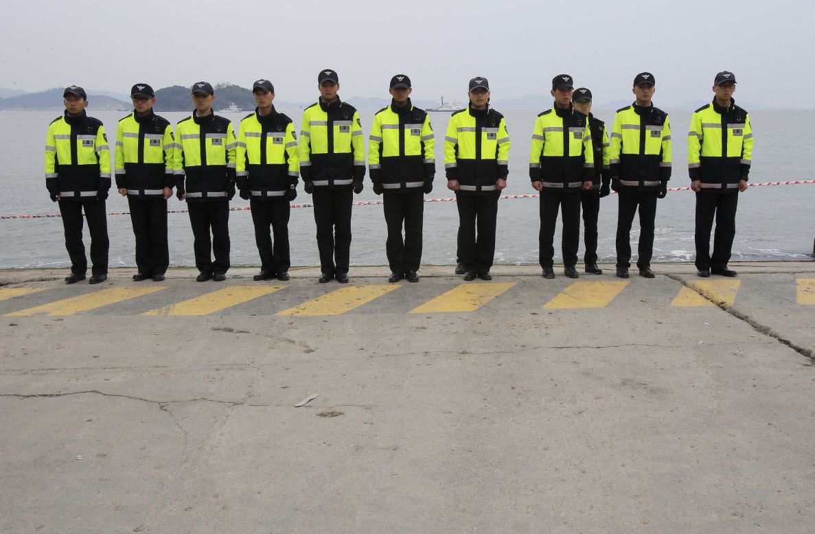 Police officers in Jindo stand guard Saturday, April 19, to prevent relatives of the ferry's missing passengers from jumping in the water. Some relatives said they will swim to the shipwreck site and find their missing family members by themselves.