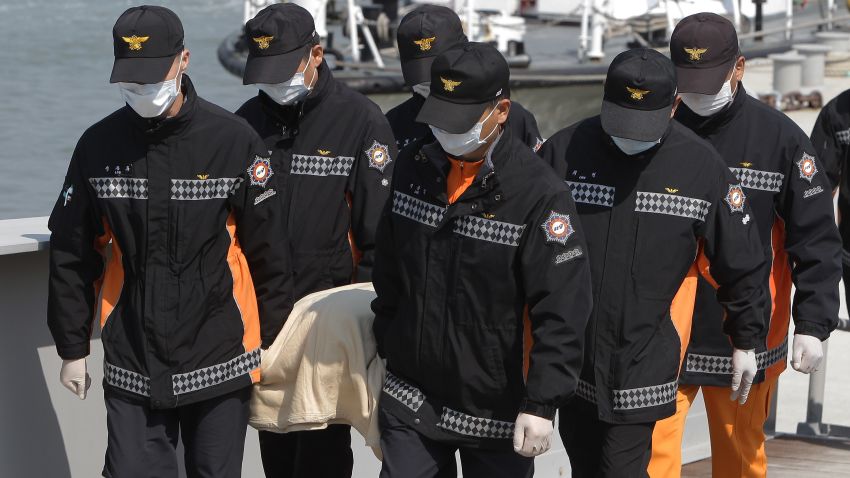 Rescue works carry a victim of the sunken ferry off the coast of Jindo Island on April 20, 2014 in Jindo-gun, South Korea. At least forty six people are reported dead, with 256 still missing. The ferry identified as the Sewol was carrying about 470 passengers, including the students and teachers, traveling to Jeju Island. (Photo by Chung Sung-Jun/Getty Images)