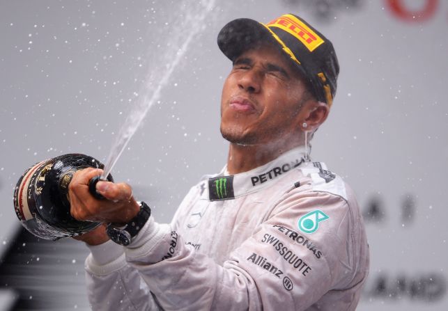 Lewis Hamilton enjoys his champagne moment after the first hat-trick of wins in his Formula One career.