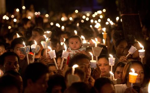 Roman Catholic devotees attend an Easter Mass outside St. Domingo Church in Manila, Phillipines.