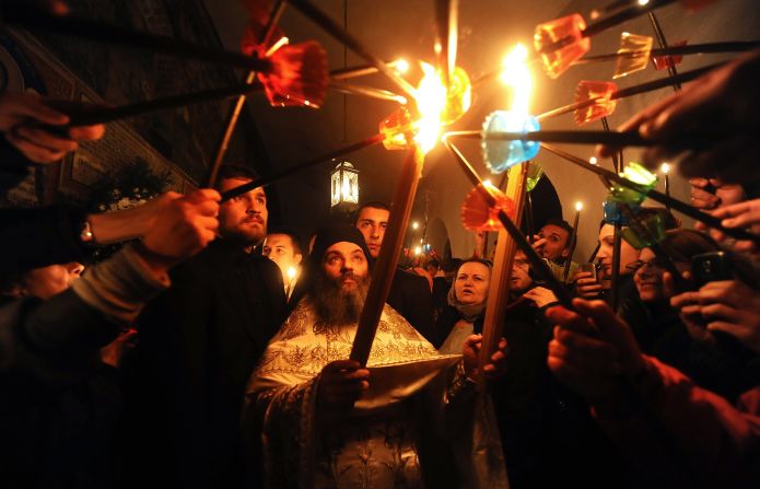 Macedonian Orthodox Christians light candles from the holy fire that arrived from Jerusalem during an Easter service at the St. Jovan Bigorski Monastery in Mavrovo, Macedonia.