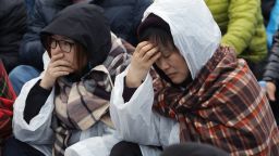 Caption:JINDO-GUN, SOUTH KOREA - APRIL 20: Relatives of missing passengers from the sunken ferry grieve as they try to go to the presidential house on April 20, 2014 in Jindo-gun, South Korea. At least forty six people are reported dead, with 256 still missing. The ferry identified as the Sewol was carrying about 470 passengers, including the students and teachers, traveling to Jeju Island. (Photo by Chung Sung-Jun/Getty Images)