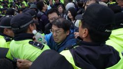 Relatives of missing passengers from the sunken ferry scuffle with police as they try to go to the presidential house on April 20, 2014 in Jindo-gun, South Korea. At least forty six people are reported dead, with 256 still missing. The ferry identified as the Sewol was carrying about 470 passengers, including the students and teachers, traveling to Jeju Island. (Photo by Chung Sung-Jun/Getty Images)