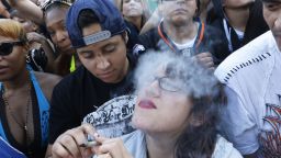 Partygoers listen to live music and smoke pot on the second of two days at the annual 420 rally in Denver, on Sunday April 20.