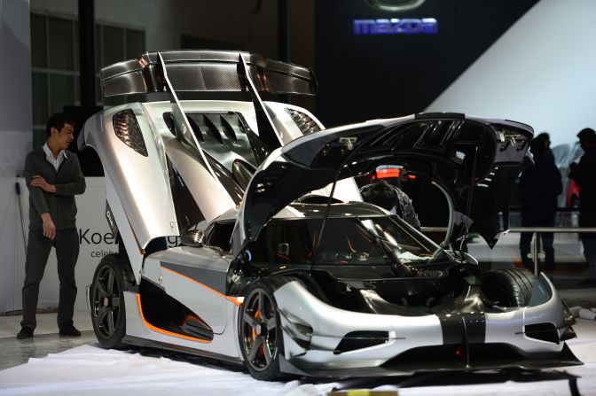Beijing police estimate an average of 120,000 people will visit the exhibition each day. This image shows a Koenigsegg car being installed at the venue.