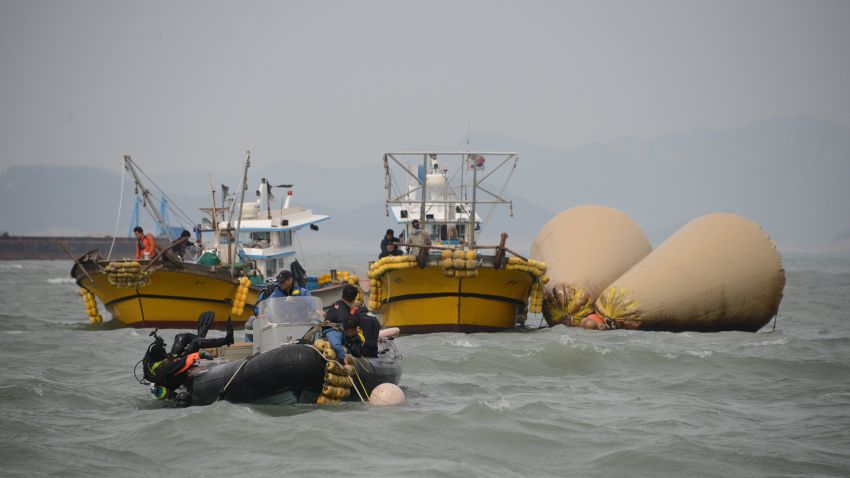 A diver enters the water at the site of the submerged 'Sewol' ferry off the coast of Jindo on April 21, 2014.
