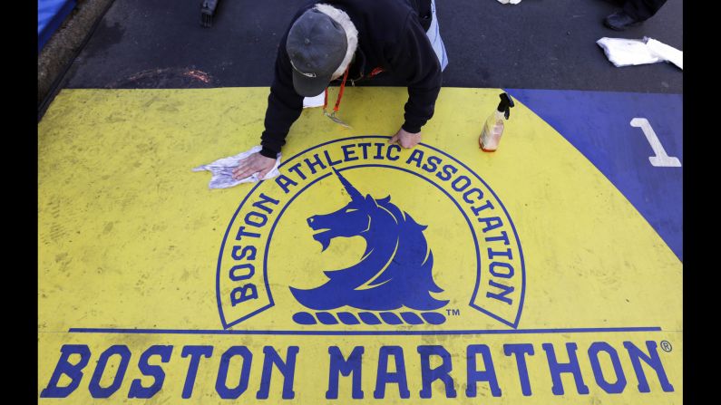 A man cleans the finish line on Boylston Street in downtown Boston before the marathon.