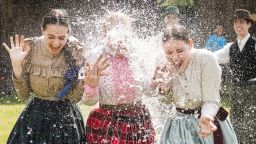 Women in traditional costumes are sprayed with water by men as members of the Marghareta Dance Group perform Easter folk traditions of the region in the Museum Village in Nyiregyhaza, 227 kms northeast of Budapest, Hungary, Monday, April 21, 2014. According to a hundred years old tradition of Hungarian villages, young men pour water on young women who in exchange present their sprinklers with beautifully coloured eggs on Easter Monday. (AP Photo/MTI/ Attila Balazs)