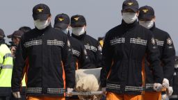 Rescue workers carry a victim of the sunken ferry off the coast of Jindo Island on April 21, 2014 in Jindo-gun, South Korea.