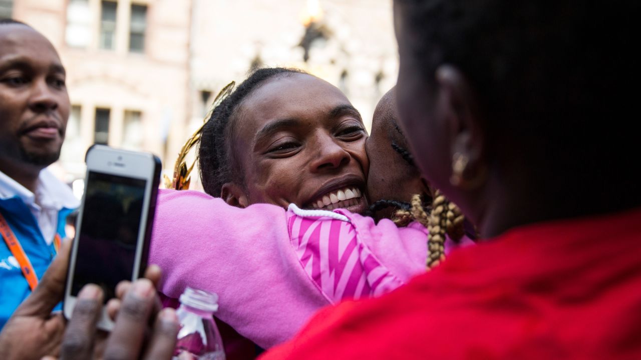 Jeptoo hugs fans after placing first in the women's division.