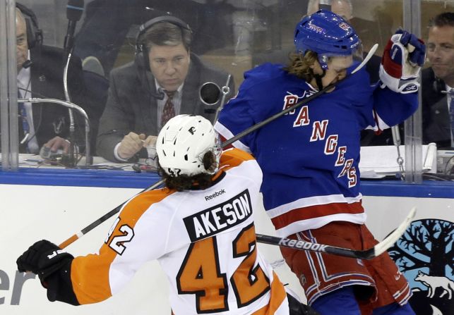 Philadelphia Flyers' Jason Akeson hits New York Rangers' Carl Hagelin in the face with his stick during a first-round playoff series on April 17 in New York. Akeson was penalized on the play. The Rangers won the game 4-1. 