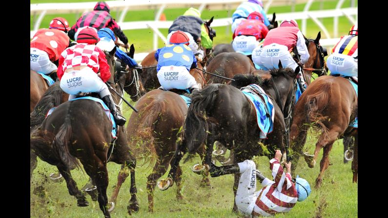 Vlad Duric falls off Golfing in in the home straight during Melbourne Racing at Caulfield Racecourse on April 19 in Melbourne. Duric suffered a minor leg injury.