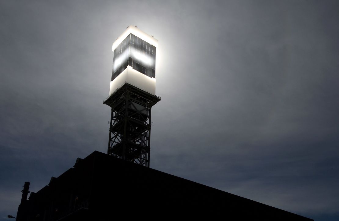 Sunlight from mirrors is reflected onto a solar receiver and boiler. Water is heated to produce steam to power turbines.