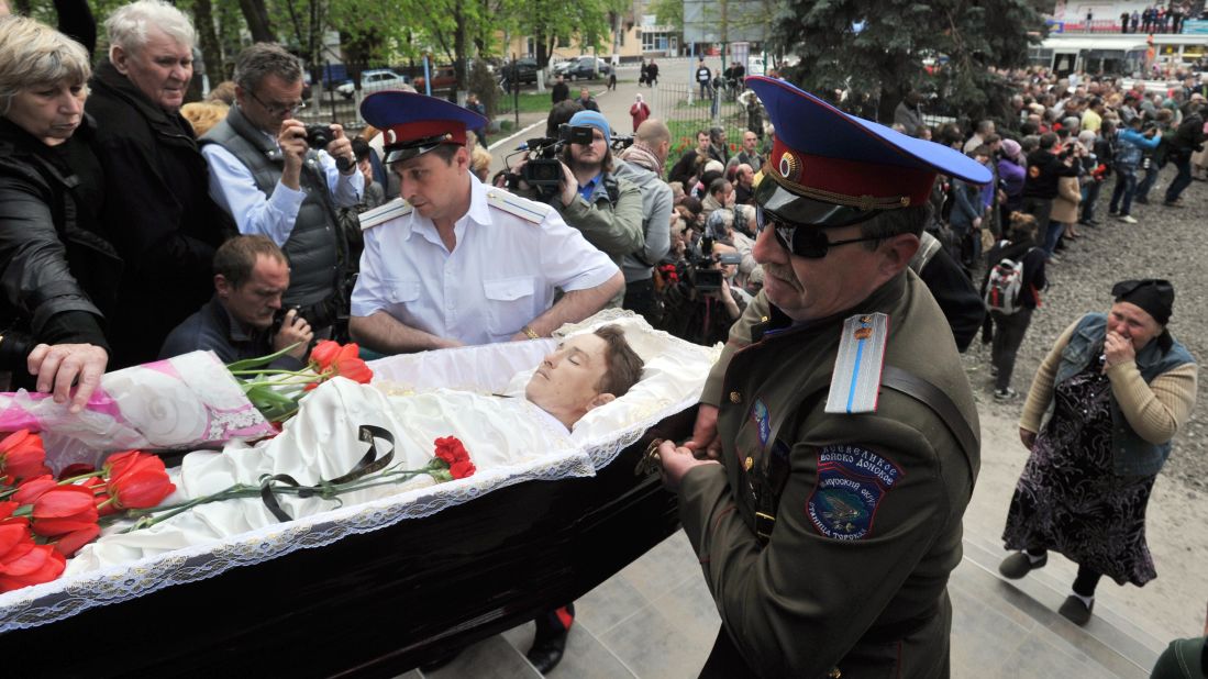 Cossacks carry a coffin into a church in Slovyansk on Tuesday, April 22, during a funeral for men killed in a gunfight at a checkpoint two days before.
