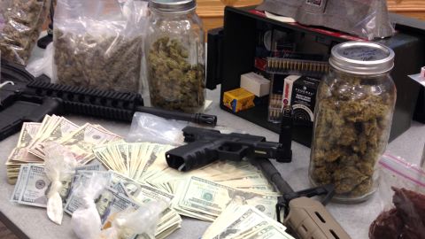 Authorities seized stacks of cash and some semi-automatic weapons
