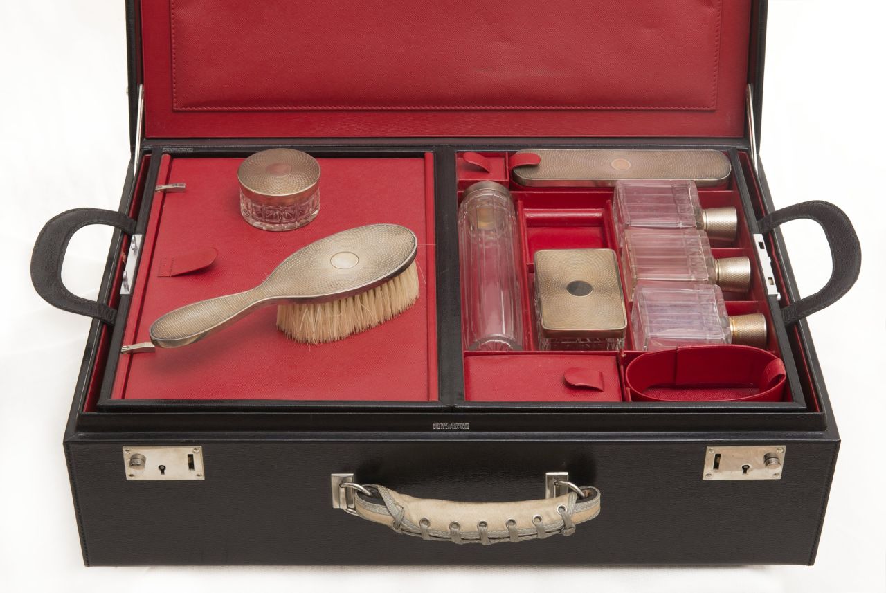Exhibition curator Claude Mollard says that he wants visitors to imagine that the train has stopped at a station, and the passengers have stepped out leaving their possessions, such as this elegant toiletry case, inside. 