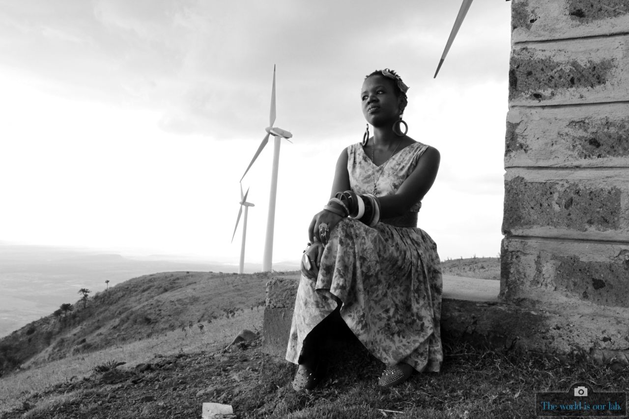In this image, a young woman sits near the turbines in the Ngong region of Kenya. Renewable energy sources have huge potential in Africa as it seeks to address its electricity shortage.