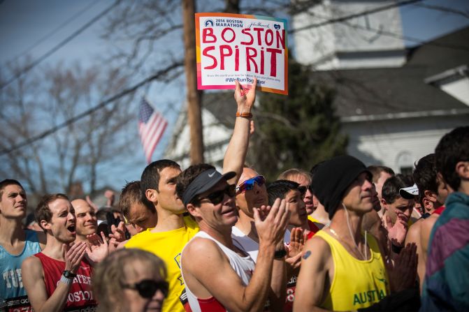 APRIL 22 - HOPKINGTON, MASSACHUSETTS: Runners wait for the starting pistol at the beginning of the 118th <a href="http://www.cnn.com/2014/04/21/us/boston-marathon/">Boston Marathon</a> on April 21. Security at the 2014 race was increased a year after two bombs were detonated close to the finish line, killing three people and injuring more than 260 others.