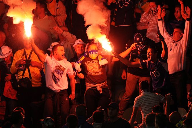 Bosnian fans light flares in celebration following Hajrovic's goal.   