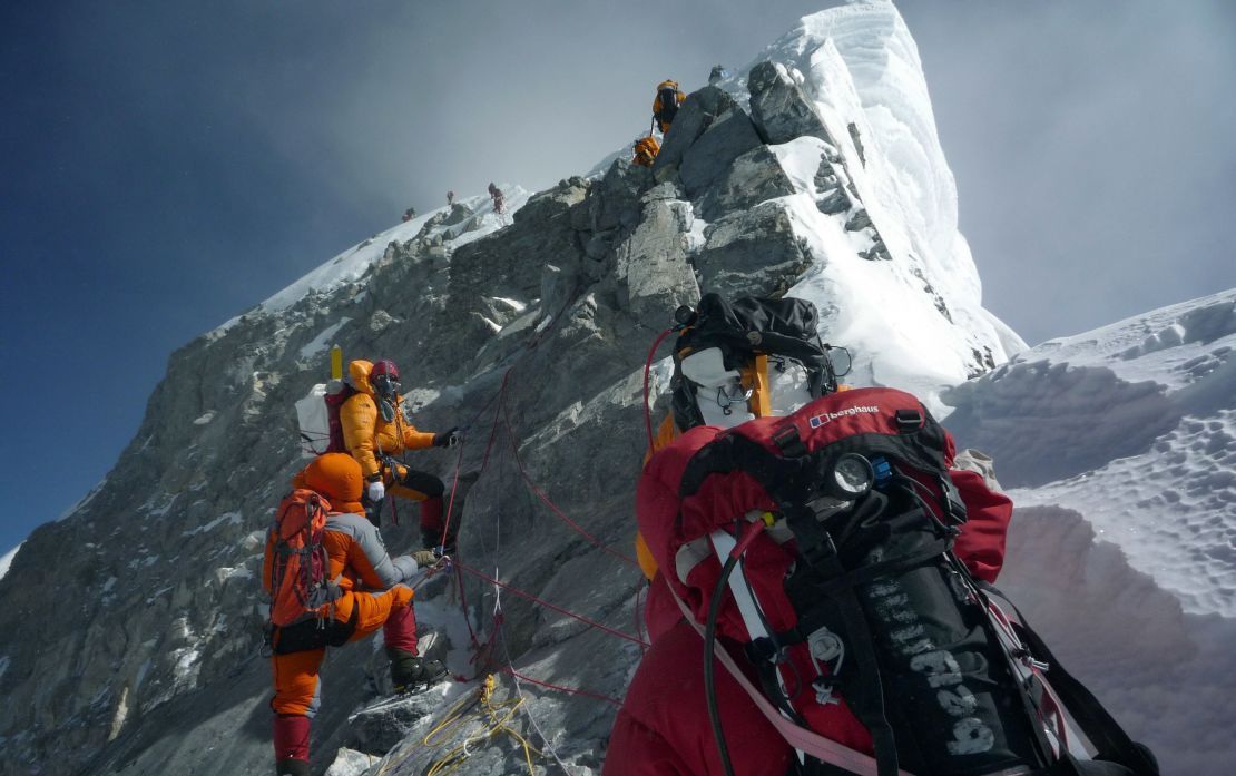 Mountaineers walk past the Hillary Step while pushing for the summit of Mount Everest as they climb the south face from Nepal, May 19, 2009.