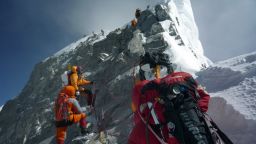 In this May 19, 2009 file photograph, unidentified mountaineers walk past the Hillary Step while pushing for the summit of Mount Everest as they climb the south face from Nepal.